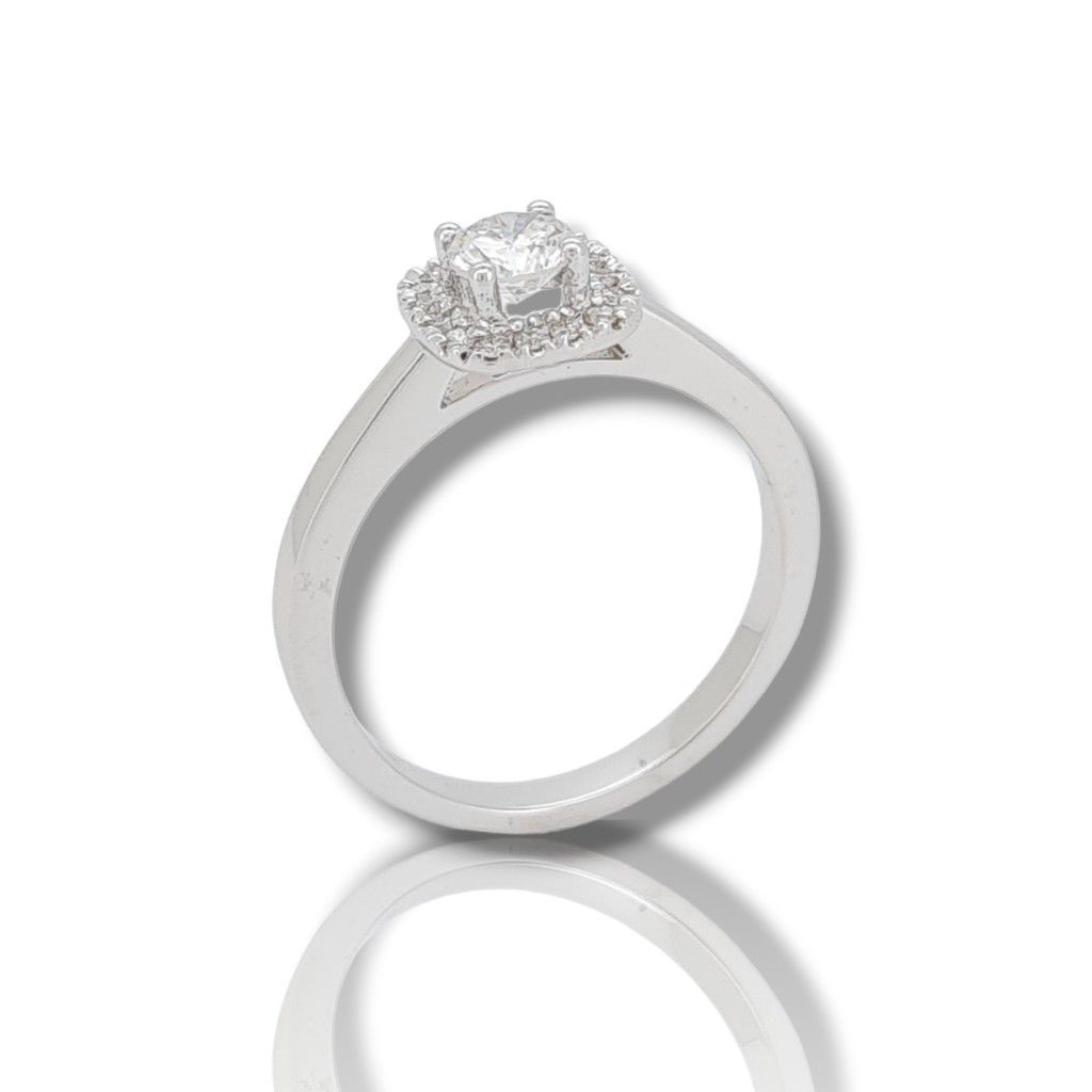 Μονόπετρο δαχτυλίδι απο λευκόχρυσο κ18 με διαμάντι κεντρικό σε τέσσερα δόντια και μικρά διαμάντια γύρω απο την κεντρική πέτρα  (code T2702)